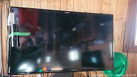Samsung 40 inch flat-screen TV with remote taped to screen