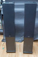 Front view of both speakers with grills installed and carpet spikes in place