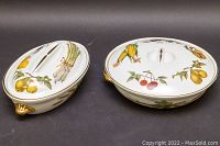 Two covered ceramic serving dishes with Evesham pattern shown from top angle.