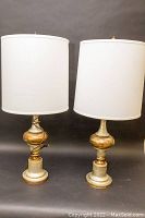 Front view of both Italian Florentine table lamps with off-white fabric shades and painted distressed bases