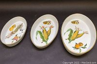 View of three oval serving dishes by Royal Worcester with vegetable and fruit designs showing all pieces in the set.