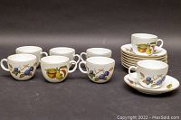 All 8 teacups displayed alongside 8 matching saucers arranged neatly