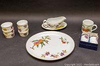 Full set view showing platter, gravy boat with under-plate, mug, 6 ramekins, and boxed egg coddlers, all with fruit motifs and gold trim.