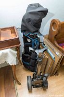 Golf bag with clubs and attached folding golf cart