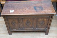 Front and top view of oak blanket box with carved Mission style diamond panel design and mark on top surface.