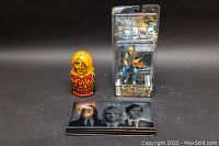 Photo showing the largest and smallest nesting doll with the boxed Kurt Cobain Unplugged figurine and Nirvana 4-disc set.