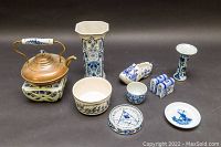 Full lot including copper stovetop kettle on ceramic heater base and eight Delft pottery pieces, various hand-painted blue and white designs.