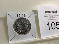 Front side of the 1940 Canadian silver half dollar coin in protective holder with year 1940 marked above.