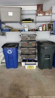 Image showing storage bins and shelving with various items including bins likely containing extension cords and miscellaneous tools.