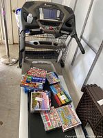 Photo showing front view of Spirit Fitness XT685 treadmill with puzzles placed on the belt for scale reference.