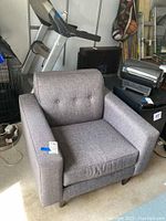 Front-left angled view showing texture and cushion details on comfort chair.