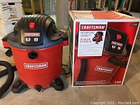 Photo of the Craftsman 20-gallon wet/dry vacuum and the original product box showing brand, capacity, and motor horsepower.