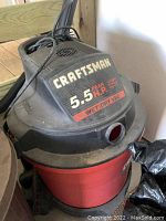 Photo of Craftsman wet/dry vacuum showing red tank and black lid with 5.5 HP label.