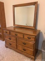 Frontal view of the dresser showing the drawers and attached mirror.