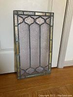 Full view of the rectangular stained glass panel showing overall design and condition