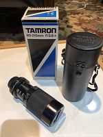 Photo showing Tamron 80-210mm F/3.8-4 zoom lens, original box, and carrying case.