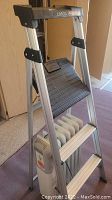 Full view of Cosco aluminum step ladder holding Lakewood heater at base