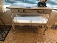 Full front view of the white wooden side table showing stone top and drawer