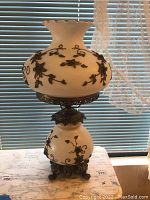 Full view of vintage glass and metal overlay lamp showing top and base.