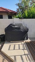 Black Weber grill cover on grill