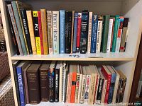 Bookshelves with various books including PCs for Dummies, history, fiction, and non-fiction titles.