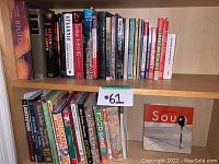 Books arranged on wooden shelves showing diverse collection