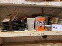 Two shelves with various containers holding nails, screws, and small hardware items arranged for sale.