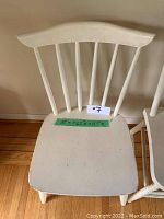 Top-down view of a white painted wood chair showing seat dimensions marked with green tape: 32"W x 14.5"D x 35.5"H.