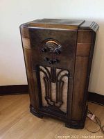 Front view of wood console radio cabinet showing overall shape and condition