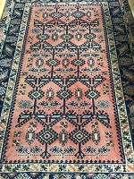 Close-up of central field showing geometric medallion pattern on rose background