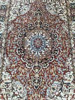 Close-up of central medallion showing rust and cream floral pattern