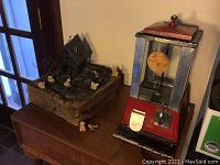 Full view of the vintage gum machine and metal farm scene sculpture with ceramic tea animals on wooden block
