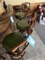 Overall front view of four bar stools positioned at bar counter.