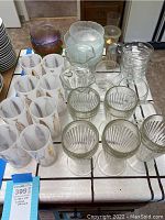 Overall lot with glasses, bowls, and shakers on table