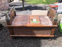 Side and top view of vintage wooden bench showing carved decorative design and flat top.