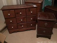 Photo showing the nine-drawer wooden cabinet with white ceramic knobs on each drawer and the nightstand beside it, illustrating the size and style of both pieces.