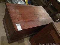 Top view of vintage wooden chest showing surface scratches and marks.