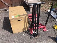 Overview showing wooden plyo box, red metal fitness frame base and black keyboard stand