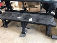 Side view showing the two-tiered heavy metal fitness bench with textured upper tier and metal feet base