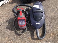Kenmore Evo canister vacuum cleaner with hose attached, shown on ground.
