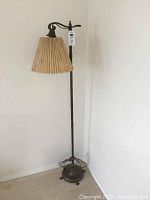 Full view of the antique floor lamp standing in corner, showing lamp height and base.