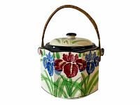 Photo of the front view of the antique Japanese biscuit jar showing floral design and woven handle.