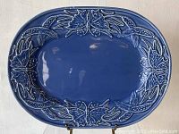 Full view of the blue vintage Bordallo Pinheiro oval platter showing butterfly and wheat relief design around edges.