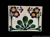 Front view of rectangular ceramic planter or vase showing the purple flowers with yellow centers and green leaves against a white crackled glaze background.