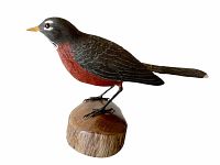 Side view photo of the hand carved and painted robin bird decoy mounted on a wooden base.