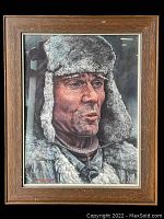 Front view of watercolor portrait in wood frame showing the man wearing a thick fur-lined hunter's hat.