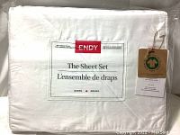 Packaged new ENDY queen size bed sheets set in white, showing front label with brand and material info.