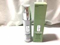 Front view of the Clinique Even Better Clinical Dark Spot Corrector bottle and its packaging box, showing brand and product name.