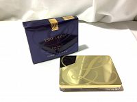 Estee Lauder Pure Color Blush compact and its outer box displayed on white surface with gold-tone case featuring logo.