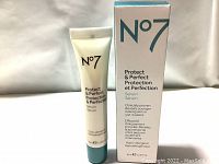Front view of N°7 Protect & Perfect Serum 30ml tube with original packaging showing product name, volume, and key claims in English and French.